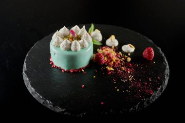 Siyah bir arka plan üzerinde ahududu ve fındık ile Cheesecake