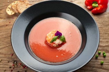 Siyah bir tabakta karides ile Gazpacho soğuk çorba