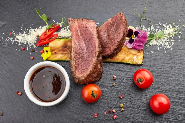 Filet Mignon steak with sauce on black slate — Stock Photo, Image