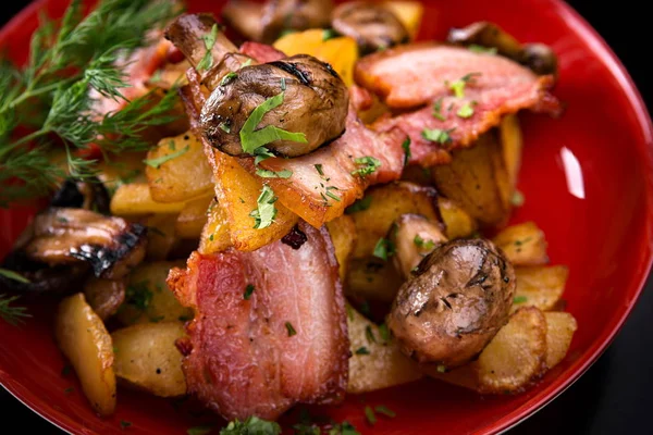 Pommes de terre frites avec bacon et champignons dans une assiette — Photo