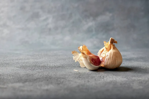 Open head of garlic on a light background