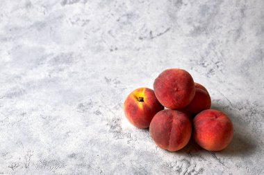 Beş olgun, sulu şeftali, beyaz benekli arka planda