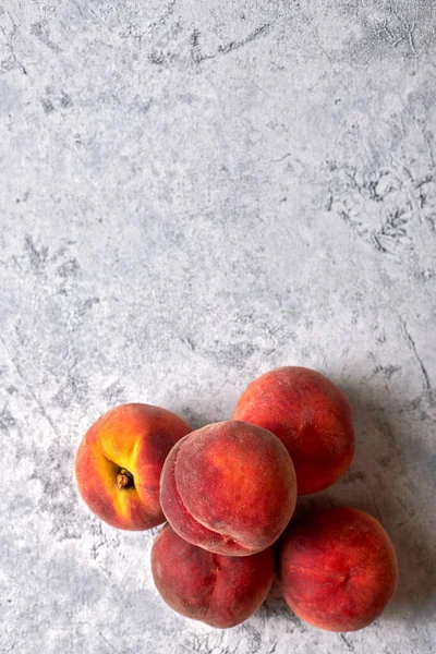 Five ripe, juicy peaches, on a white spotted background