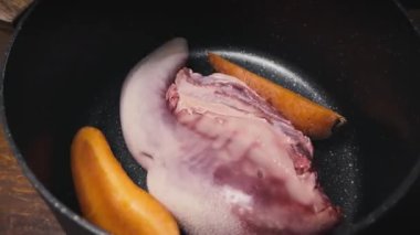 Profesyonel şef bir tencerede sığır dili haşlıyor. Mutfakta geleneksel et hazırlama videosu.