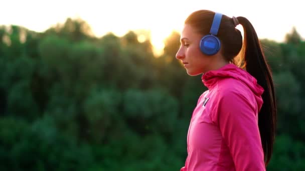 Girl Pink Jacket Preparing Run Warm Listen Music Headphones Phone — Stock Video