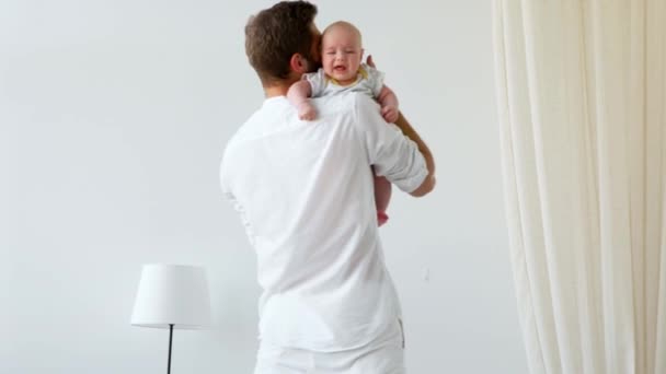 Unrecognizable father caressing crying newborn baby son — Stock Video