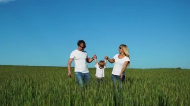 Anne baba ve oğul alanında dikenli ellerinde sallanan beyaz t-shirt ve jeans eğlenceli yürümek