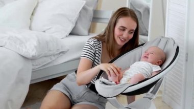 Beyaz yatak odasında online alışveriş yapan izinli bebeğin yanında uyuyan hamile iken,