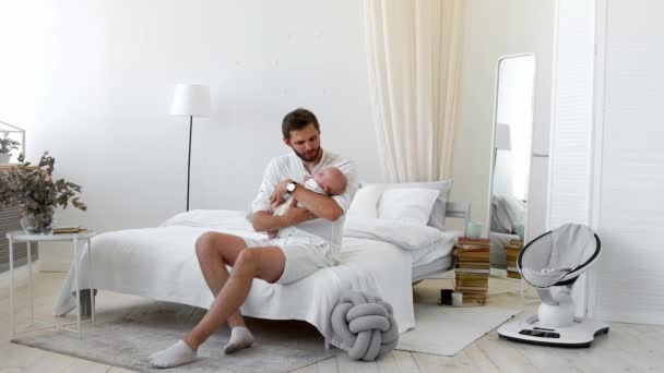Dumny ojciec trzymający córki nowo narodzonego dziecka w jego w domu — Wideo stockowe