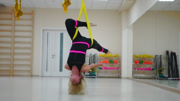 La ragazza sulla lezione anti-gravità su Aero yoga sulle tele fa una rotazione a testa in giù in aria. Telecamera al rallentatore — Video Stock