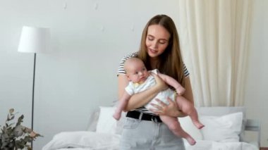 Beyaz bir daire içinde modern bir genç Aile kavramı. Anne bebek ona ninni şarkı yatağa koyar.