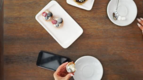 Freshly baked blueberry muffins in a rustic setting with milk and coffee on the table overhead shot with copyspace — Stock Video