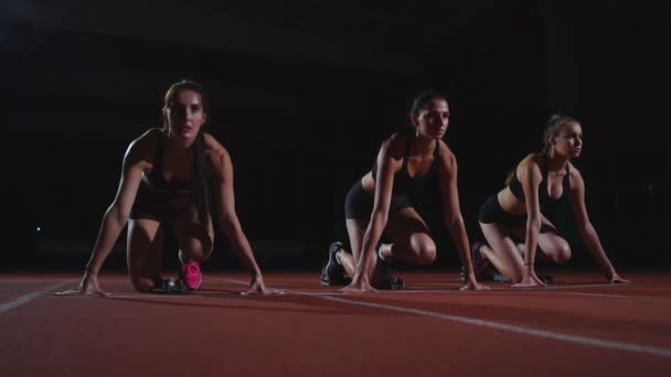 Female athletes warming up at running track before a race. In slow motion — Stock Video