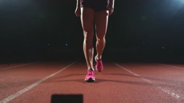 Yakın çekim bacaklar sporcunun koşu bandı yaklaşım ve yarış başlatmak için konumda olmak