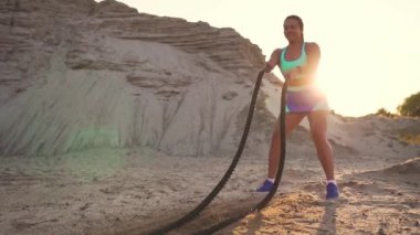 Atletik kadın açık bir iple CrossFit egzersizleri yapıyor