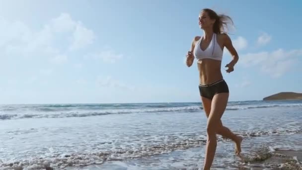 跑步的女人, 在沙滩上户外运动中的女亚军慢跑. 户外健身模式. — 图库视频影像