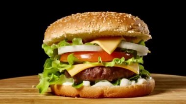 Marul ve mayonez ile ev yapımı sığır eti hamburger closeup küçük ahşap kesme tahtası üzerinde servis. Koyu arka plan