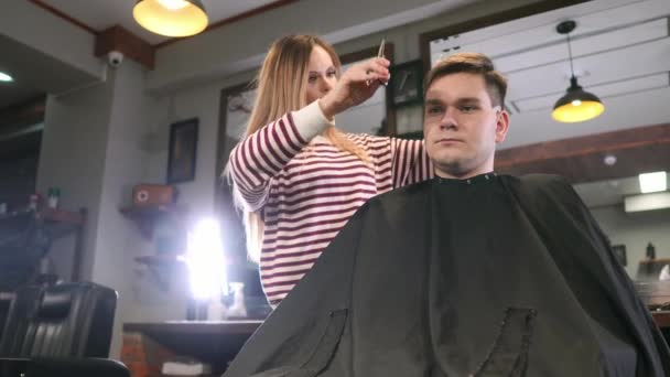 Rückansicht eines Mannes, der Friseur und Friseur im Friseursalon besucht. — Stockvideo