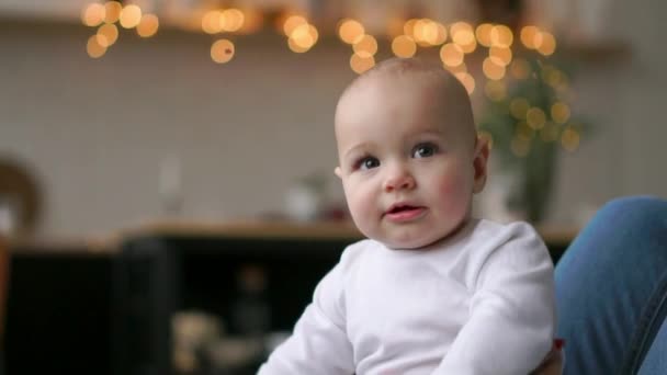 Los mejores momentos de la vida, una amorosa madre joven y feliz abraza a un hijo lactante, sobre una manta blanca como la nieve, sobre un fondo blanco. concepto de amor, familia y felicidad Concepto: niños, niños, bebés, bebés — Vídeo de stock