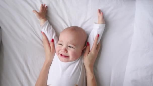 Lindo bebé de cuatro meses envuelto en toallas después de la ducha en la cama en casa — Vídeos de Stock