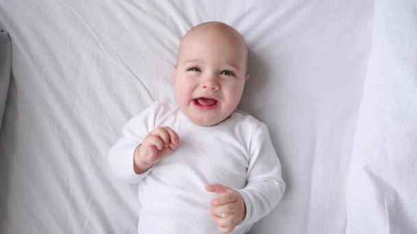 Cute little baby lying on bed, top view — Stock Video