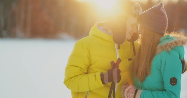 Look at each other with loving eyes while skiing in the winter forest. a married couple practices a healthy lifestyle — Stock Video