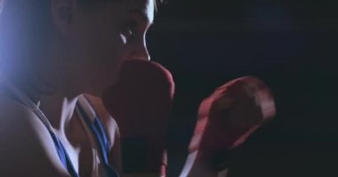 Güzel kadın boksör karanlık bir spor salonunda tren ve yumruklar yavaş dışarı çalışır