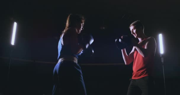 Fitness mujer atleta boxeo puñetazos foco guantes disfrutando de ejercicio intenso mujer luchadora entrenamiento amigo en gimnasio entrenamiento juntos cámara lenta — Vídeos de Stock