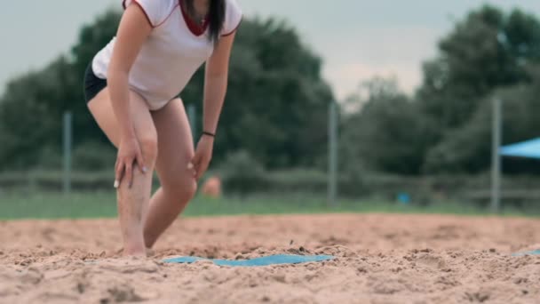 Female volleyball player in the fall hits the ball in slow motion on the beach. — Stock Video