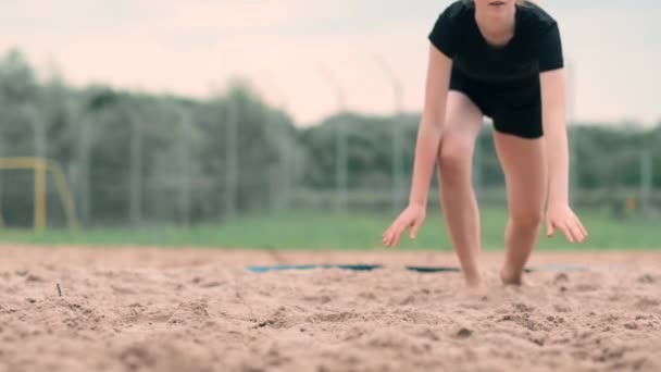 Unga kvinnliga idrottare i sanden och sparar en punkt under beachvolleyboll match. Glad kaukasiska flicka hoppar och kraschar in i den vita sanden under en beachvolley turnering — Stockvideo