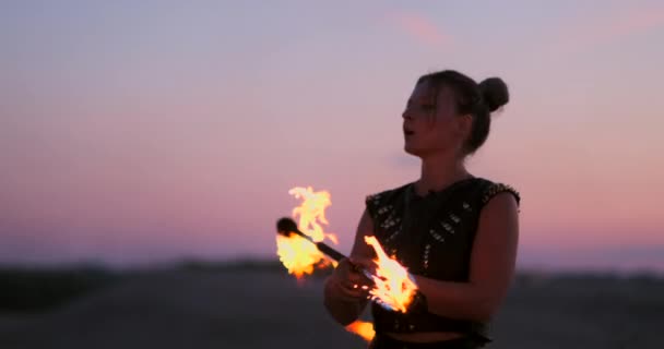 A group of professional circus performers with fire shows dance shows in slow motion using flame-throwers and rotating the torches burning objects. — Stock Video