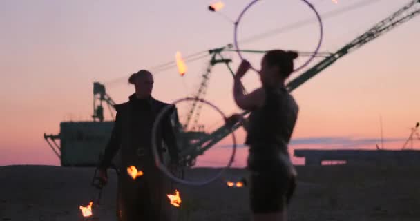 Танцюристи проти заходу сонця. Молода жінка позує з вогняним кільцем на захід сонця під час її танцювального виступу . — стокове відео