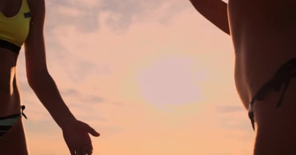 Two young girls giving high fives after volleyball match, — Stock Video