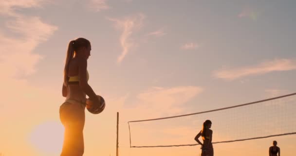 Beach volleyball serve - woman serving in beach volley ball game. Overhand spike serve. Young people having fun in the sun living healthy active sports lifestyle outdoors. — Stock Video