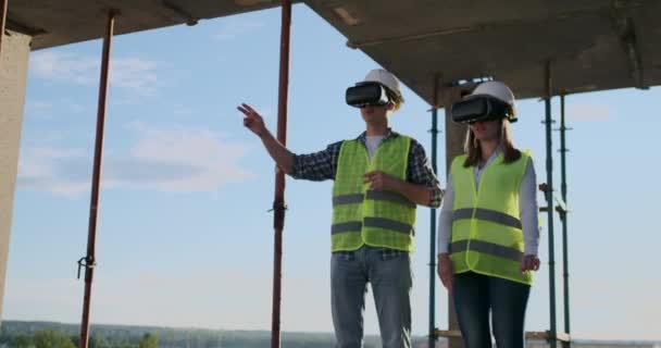 Huvud ingenjörerna i fabriken som transporterar VR-headsetet designar byggnaden på byggplatsen. Applikationer för virtuell Mixad verklighet. — Stockvideo