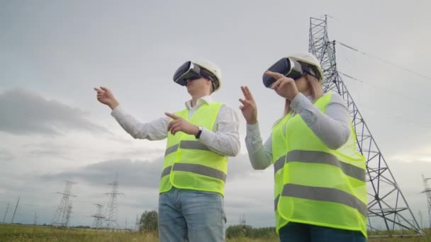 Twee ingenieurs van Power Engineers in vr-brillen bewegen hun handen om de werking van de interface van het besturingssysteem te simuleren — Stockvideo