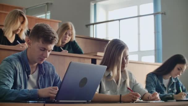 Large Group of Multi Ethnic Students Working on the Laptops while Listening to a Lecture in the Modern Classroom. Bright Young People Study at University — Stock Video