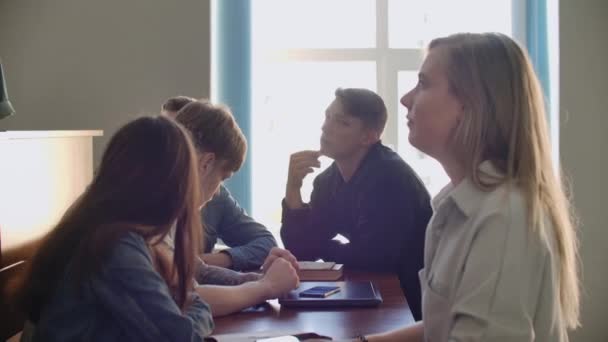 Friendly student group talking in classroom having break between lessons — Stock Video