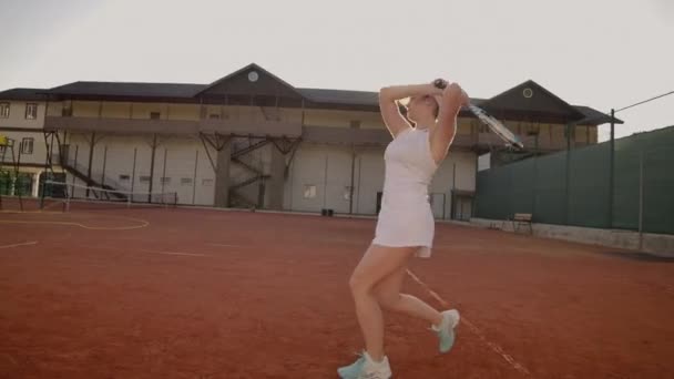 Tennis Player Reaching To Hit Ball. Female tennis player reaching to hit the tennis ball on court. — Stock Video