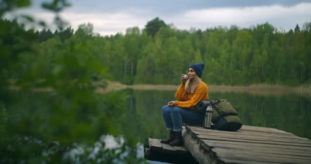 Belo viajante feminino ou mochileiro descansar na vista incrível da natureza desfrutando de chá ou bebida de thermos único lago de montanha verde em férias — Vídeo de Stock