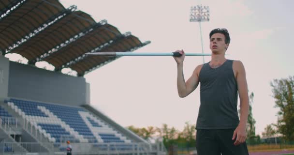 A male athlete throws javelins at a stadium in slow motion. Athletics javelin throw Olympic program — Stock Video