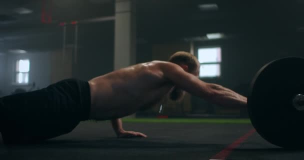 Um homem forte é pressionado em uma mão no ginásio com um vapor em seu corpo . — Vídeo de Stock
