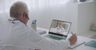 İki tıp uzmanı internette video konferansı, danışmanlık ve danışmanlık ve deneyim alışverişi ile sohbet ediyorlar.