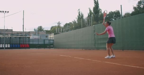 Pemain tenis wanita beraksi selama pertandingan di stadion profesional. Dia mengenakan pakaian olahraga tanpa merek. Stadion. — Stok Video