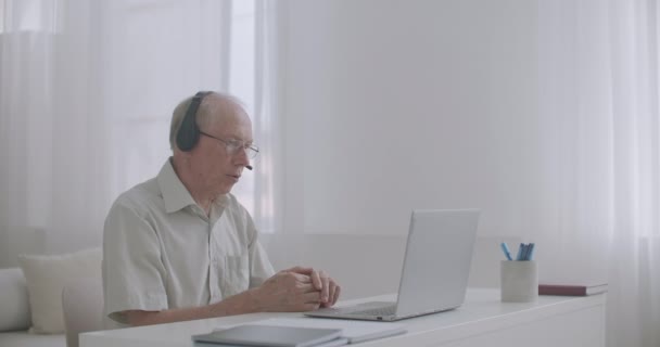 Man is working on retirement, consulting client online, staying home, using notebook with internet connection — Stock Video