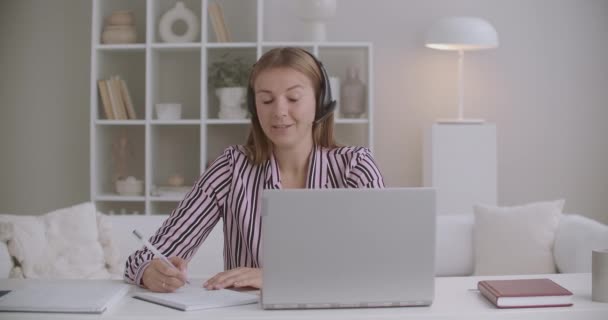 Młoda kobieta HR manager jest wywiad przez videochat na laptopie, rozmowa kwalifikacyjna przez internet, notatki w copybook, komunikacja na odległość — Wideo stockowe