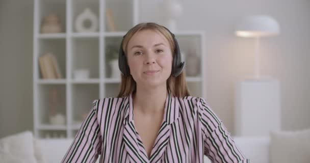 Νεαρή γυναίκα ειδικός μιλάει στο μικρόφωνο σε ασύρματα ακουστικά, videocall έννοια, εργασία από το σπίτι, μακρινή επικοινωνία — Αρχείο Βίντεο