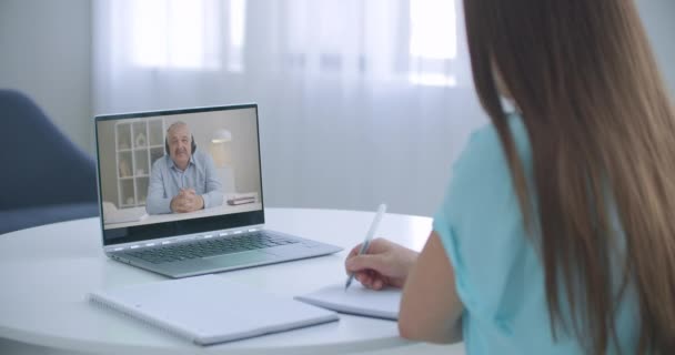Distance teacher online tutor conferencing on laptop communicate with pupil by webcam video call e-learning. Home quarantine distance learning and working at home. — Stock Video