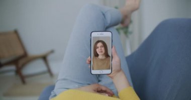 Genç kadın arkadaşlarıyla görüntülü sohbet ederken akıllı telefonlardan el sallayarak selamlaşırken izolasyon sırasındaki en iyi arkadaşlar uzun mesafe iletişiminin keyfini çıkarıyorlar.