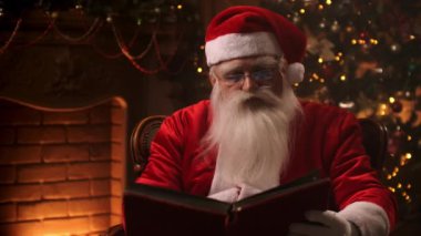 Sevgili Noel Baba evinde şöminenin yanında ve Noel ağacı Noel için hazır.
